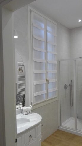 La sala da bagno in bianco e la tenda a pannello con balze in lino calandrato. Mariano, negozi tende a verona.